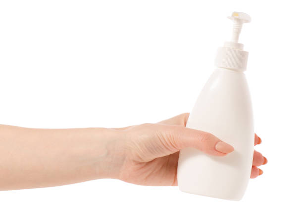 istock White soap bottle with dispenser in hand 923497716