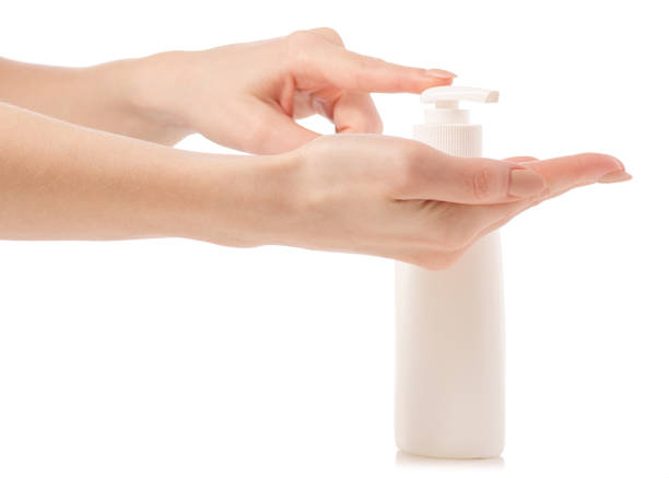 istock White soap bottle with dispenser in hand 923497792
