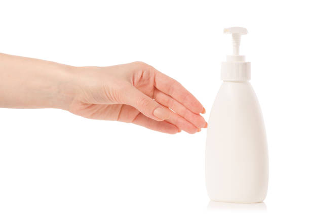 istock White soap bottle with dispenser in hand 923497850