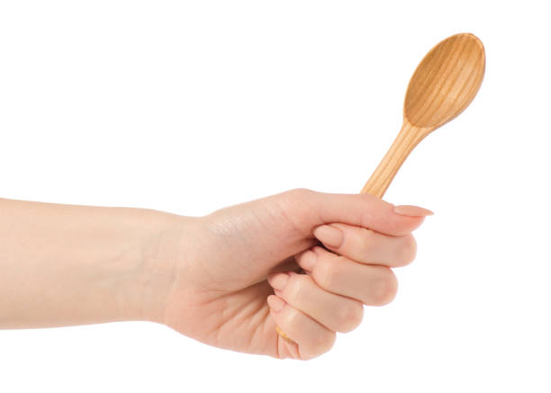 istock Wooden small spoon in hand 923497932