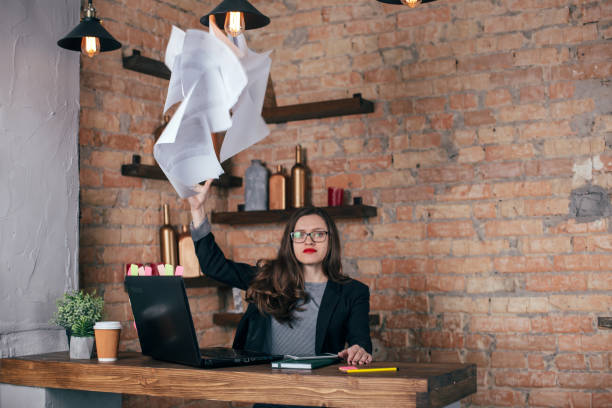 istock Young freelancer girl is working hard in laptop in loft interior 923498694