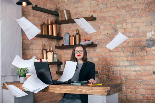 istock Young freelancer girl is working hard in laptop in loft interior 923498732