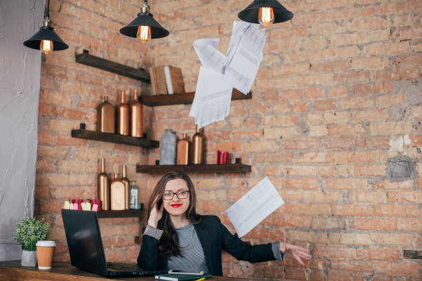 istock Young freelancer girl is working hard in laptop in loft interior 923498752