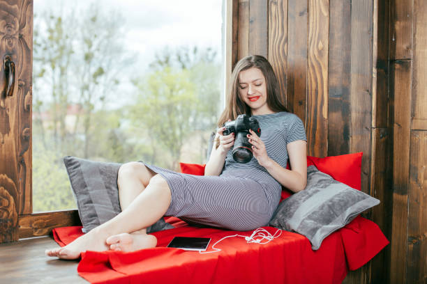 istock Young freelancer girl with a camera in loft interior 923501012