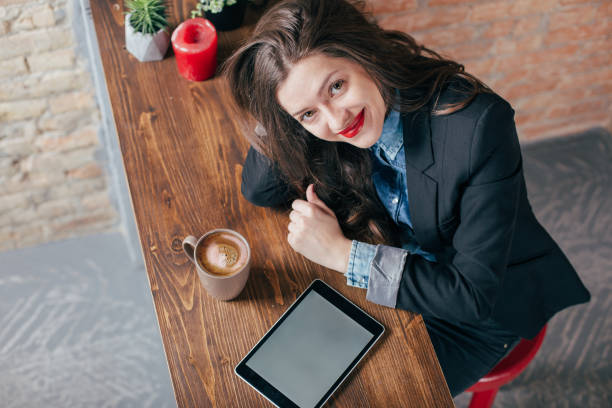 istock Young freelancer girl is working hard in laptop in loft interior 923501300