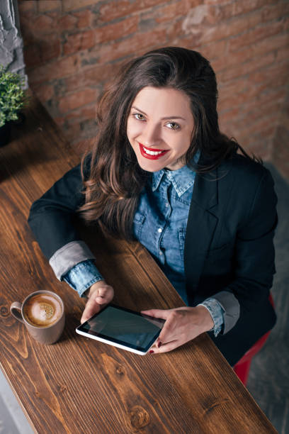 istock Young freelancer girl is working hard in laptop in loft interior 923501344