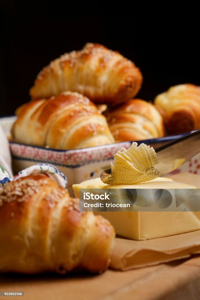 Freshly baked croissants and butter on the table Baked Stock Photo