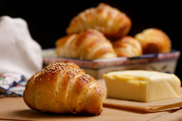 istock Freshly baked croissants and butter on the table 923504292