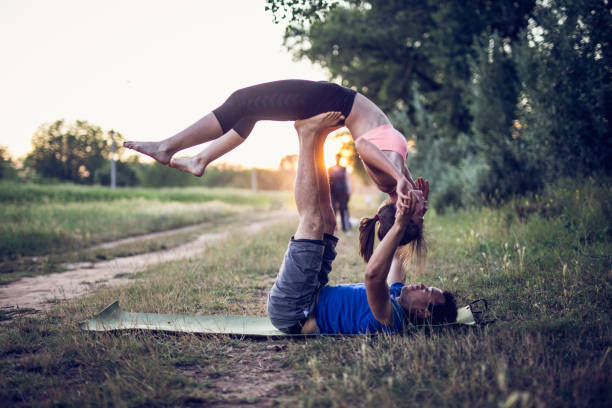istock Couple is doing wheel yoga pose 923504474