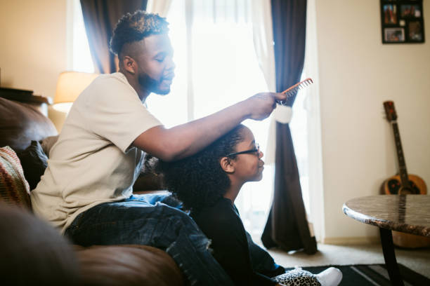 istock Supportive Father Helps Daughter Braid Hair 923505338