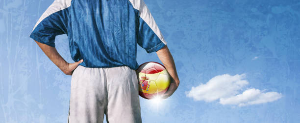 istock Spain soccer player holding ball with spanish flag 923509032
