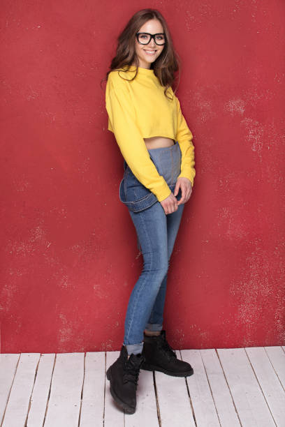 istock Happy girl smiling, standing on red background. 923511690