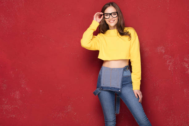 istock Happy girl smiling, standing on red background. 923514762