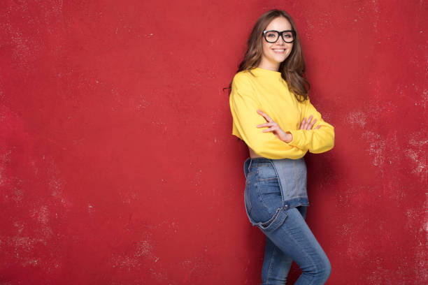 istock Happy girl smiling, standing on red background. 923514784