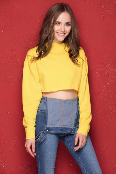 istock Happy girl smiling, standing on red background. 923514798