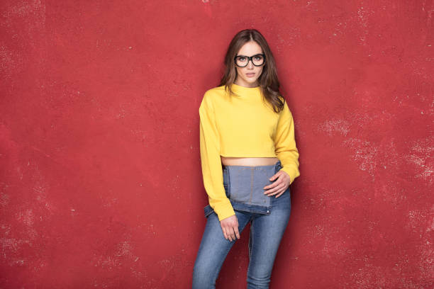istock Happy girl standing on red background. 923514978