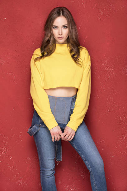 istock Happy girl smiling, standing on red background. 923518626