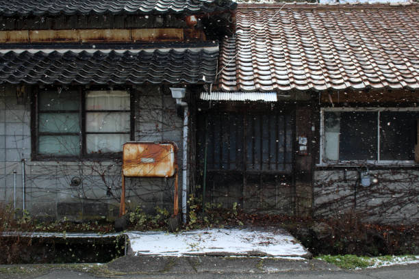 The old abandoned Japanese house during winter (snowing) stock photo