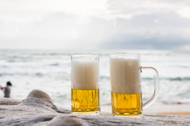 istock Glass of beer on a beach 923519518