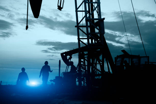 istock oil field, the oil workers are working 923519738