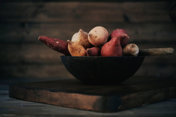 istock Still life of assorted potatoes shot in dark moody light 923536384