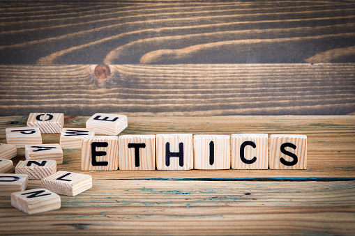Ethics. Wooden letters on the office desk, informative and communication background
