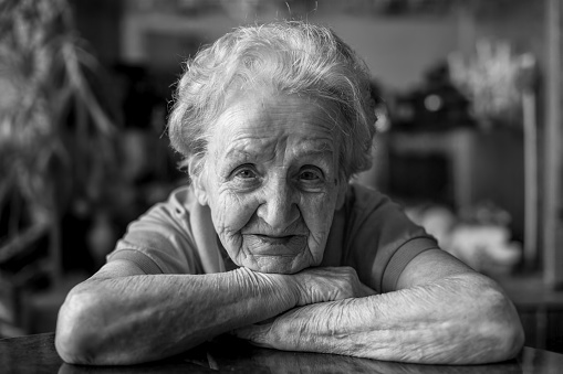 Black and white close-up portrait of an elderly lady.