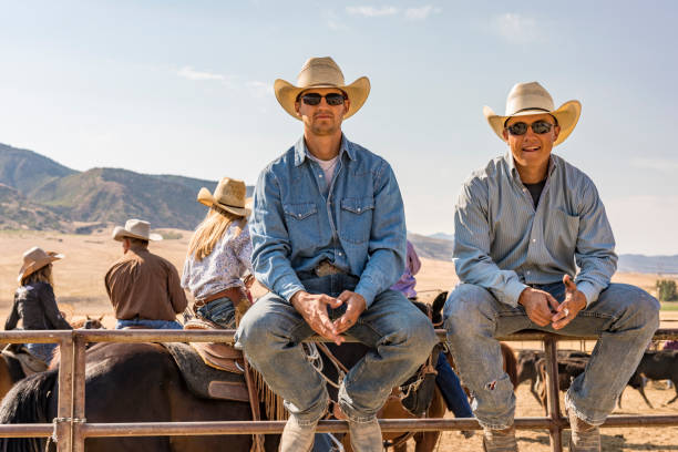 istock Young Cowboys Sitting on a Yard Fence 923543278