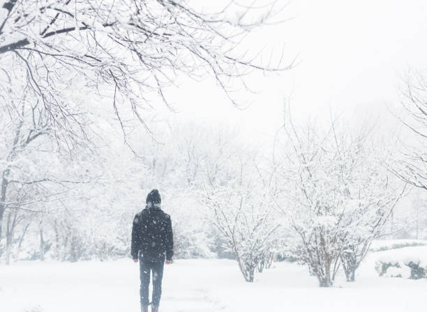 istock young man standing in the snow 923543618