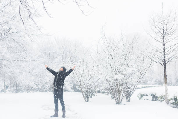 istock young man stretching his arms in the snow 923543806