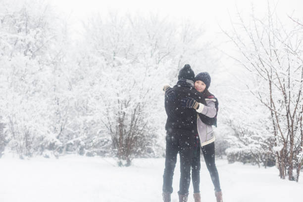 affectionate couple standing in winter landscape,China.