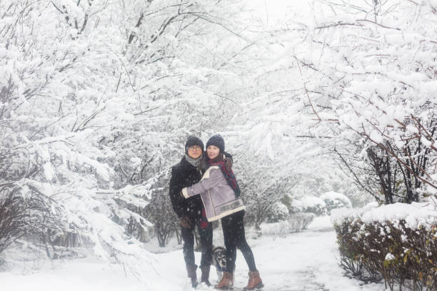 istock affectionate couple standing in winter landscape 923546154