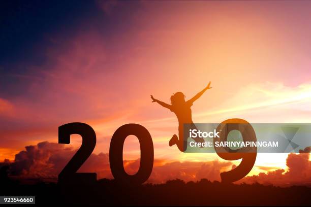Silhouette Young Woman Jumping To 2019 New Year Stock Photo - Download Image Now - Change, Dreamlike, In Silhouette