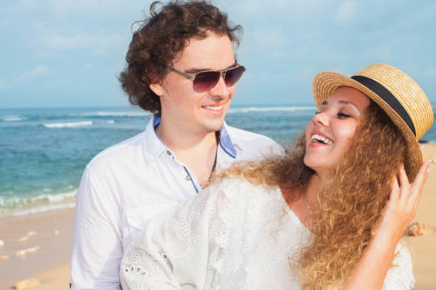 istock Wedding couple just married holds hands and walking at beach 923549858