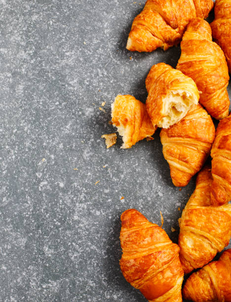 istock Fresh croissants on a grey background. Top view 923552558