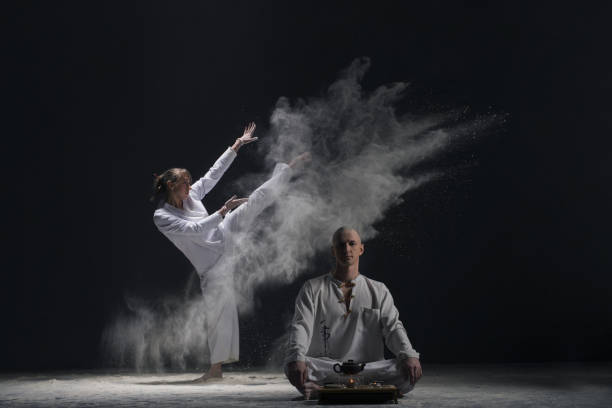 istock Two male doing yoga in a white dust cloud view 923554118