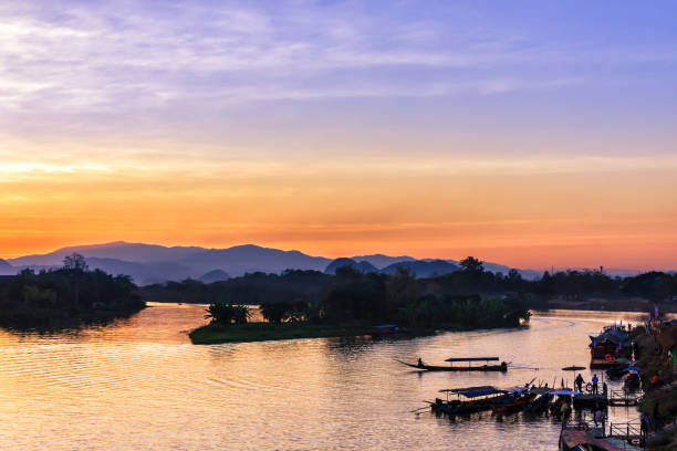 istock Silhouette boat in river Chiangrai Thailand during sunset, sky burst 923559164