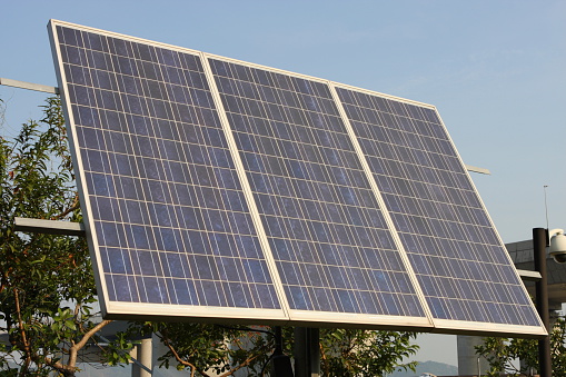 Aerial view of solar panels or solar cells on the roof of shopping mall building rooftop. Power plant, renewable clean energy source. Eco technology for electric power in industry.