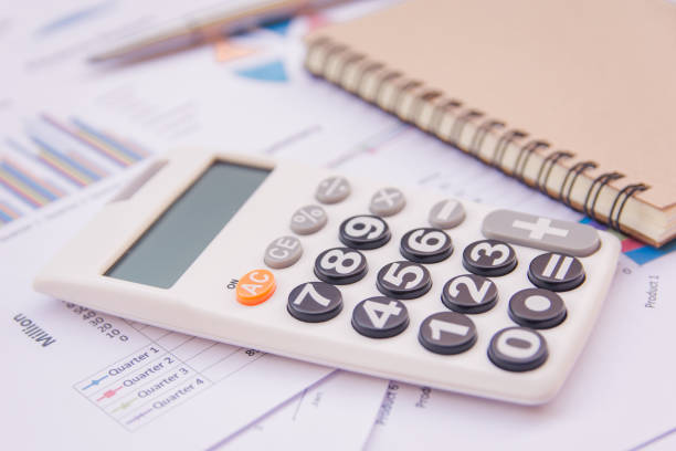 istock data analyzing with calculator, notebook and pen. on charts and graph to find out the result. 923569136