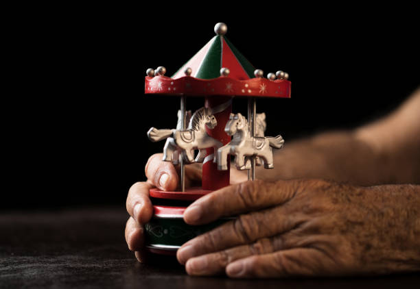 Senior hands with toy Merry-go-round