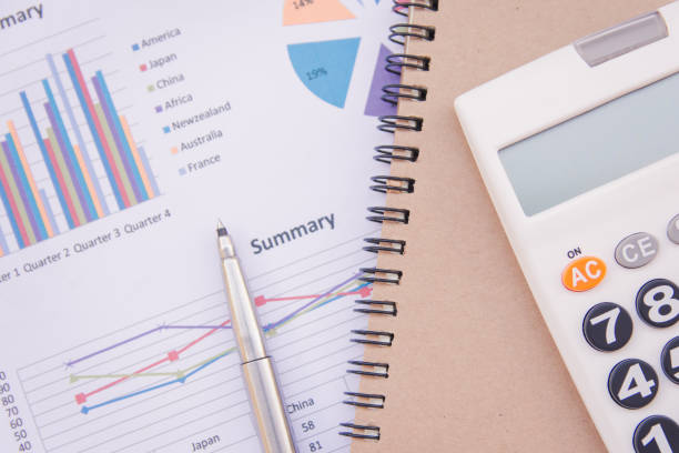 istock data analyzing with calculator, notebook and pen. on charts and graph to find out the result. 923574018