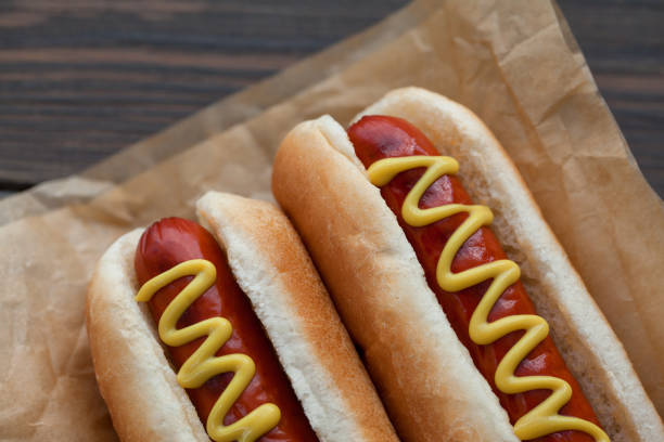 istock Barbecue Grilled Hot Dog with Yellow Mustard on wooden table 923577708