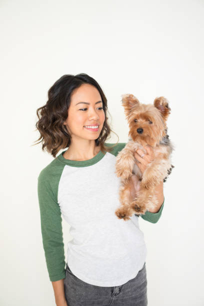 istock Happy Pretty Woman Holding Yorkshire Terrier 923578350