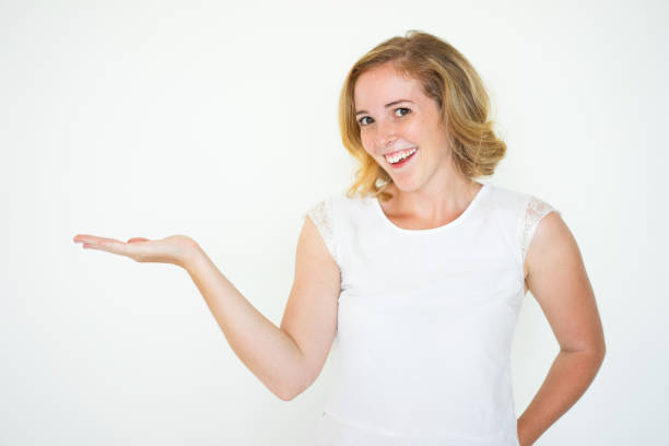 istock Smiling Cute Woman Holding Empty Space on Palm 923578440