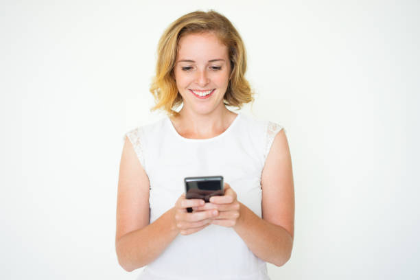 istock Smiling Pretty Woman Texting on Smartphone 923578450