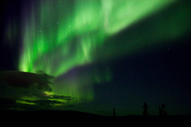 istock Vibrating Aurora Arc with Big Dipper and clouds near horizon 92358073