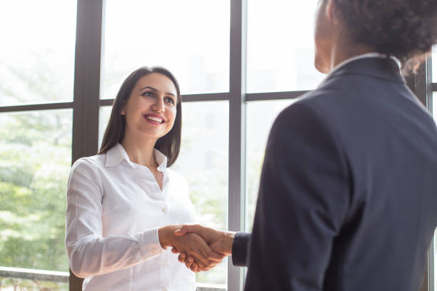 istock Cheerful confident female manager concluding deal 923582094