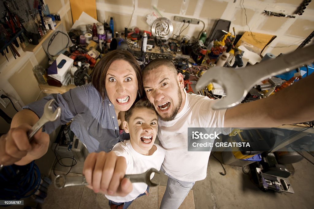 Crazy Do-It-Yourself family with wrenches  Family Stock Photo