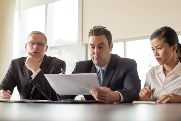 istock Pensive Business People Reviewing Documents 923588276