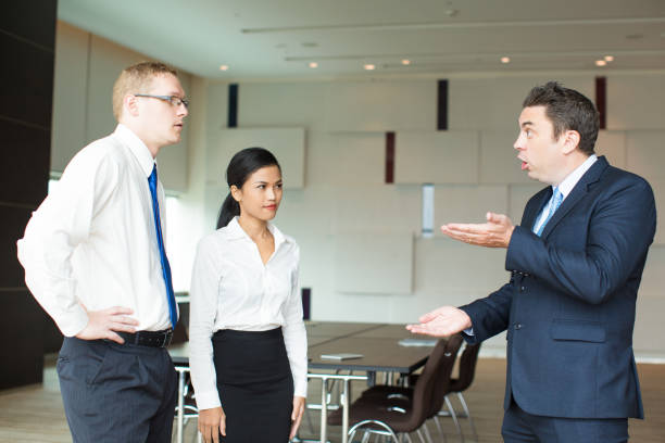 istock Irritated executive scolding young employees 923588344